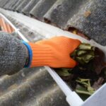 Image of a gutter being cleaned out.
