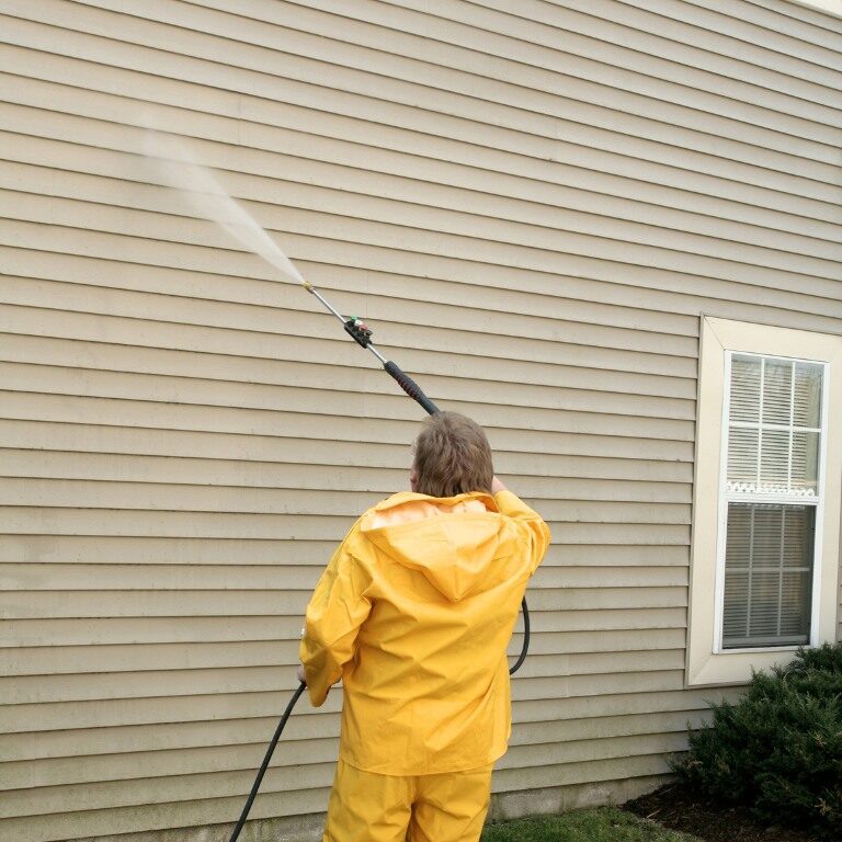 Image of a professional power washing siding on a Connecticut home.